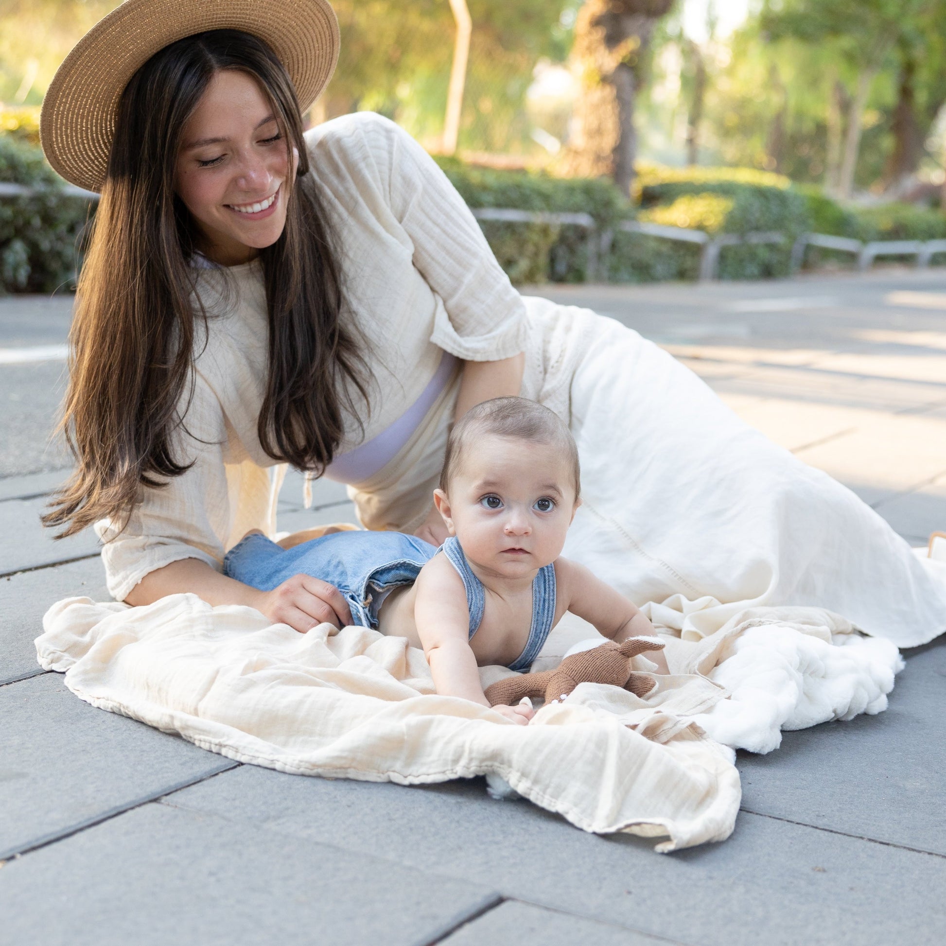 mom and baby on soft blanket outdoors